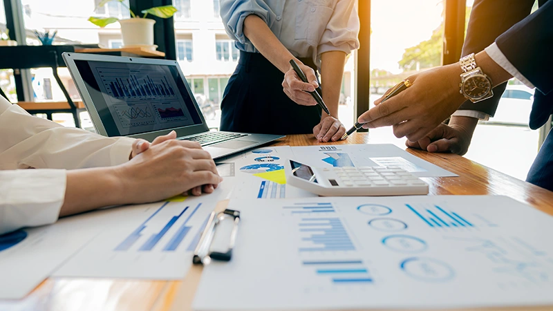 Business meeting with data analysis charts