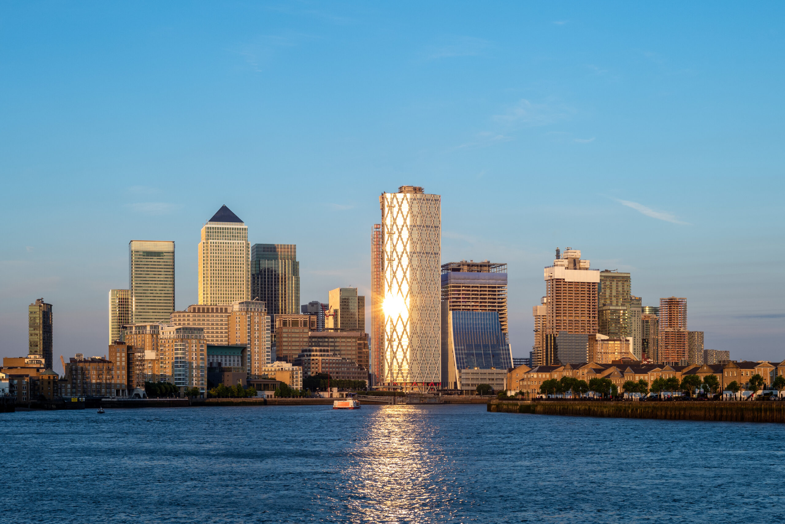 Canary Wharf financial district skyline at sunset, London, viewed across the River Thames
